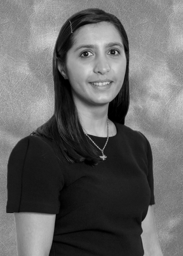 Professional headshot of Zarine Manekshaw, the new Treasurer for Be United (SCIO). She is a woman with medium-length dark hair, wearing a black top and a necklace, smiling at the camera.